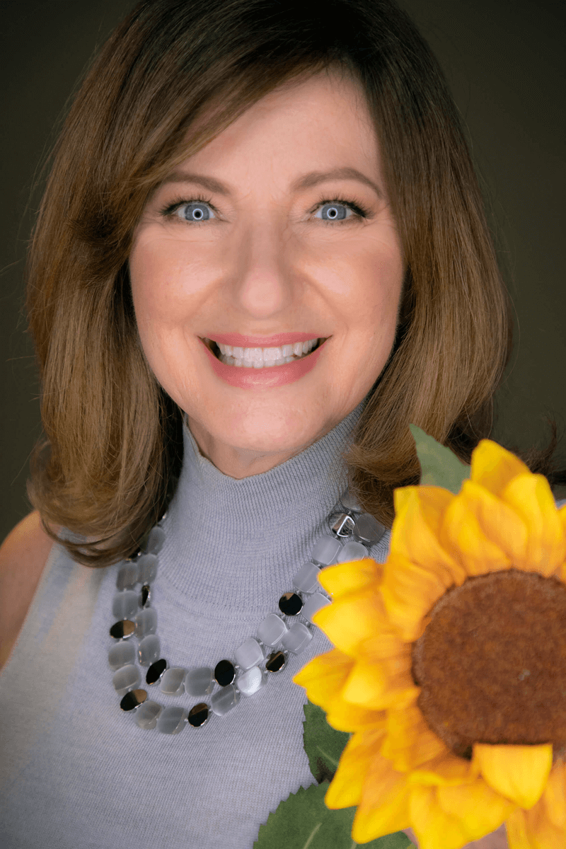 A woman with a sunflower in her hand.